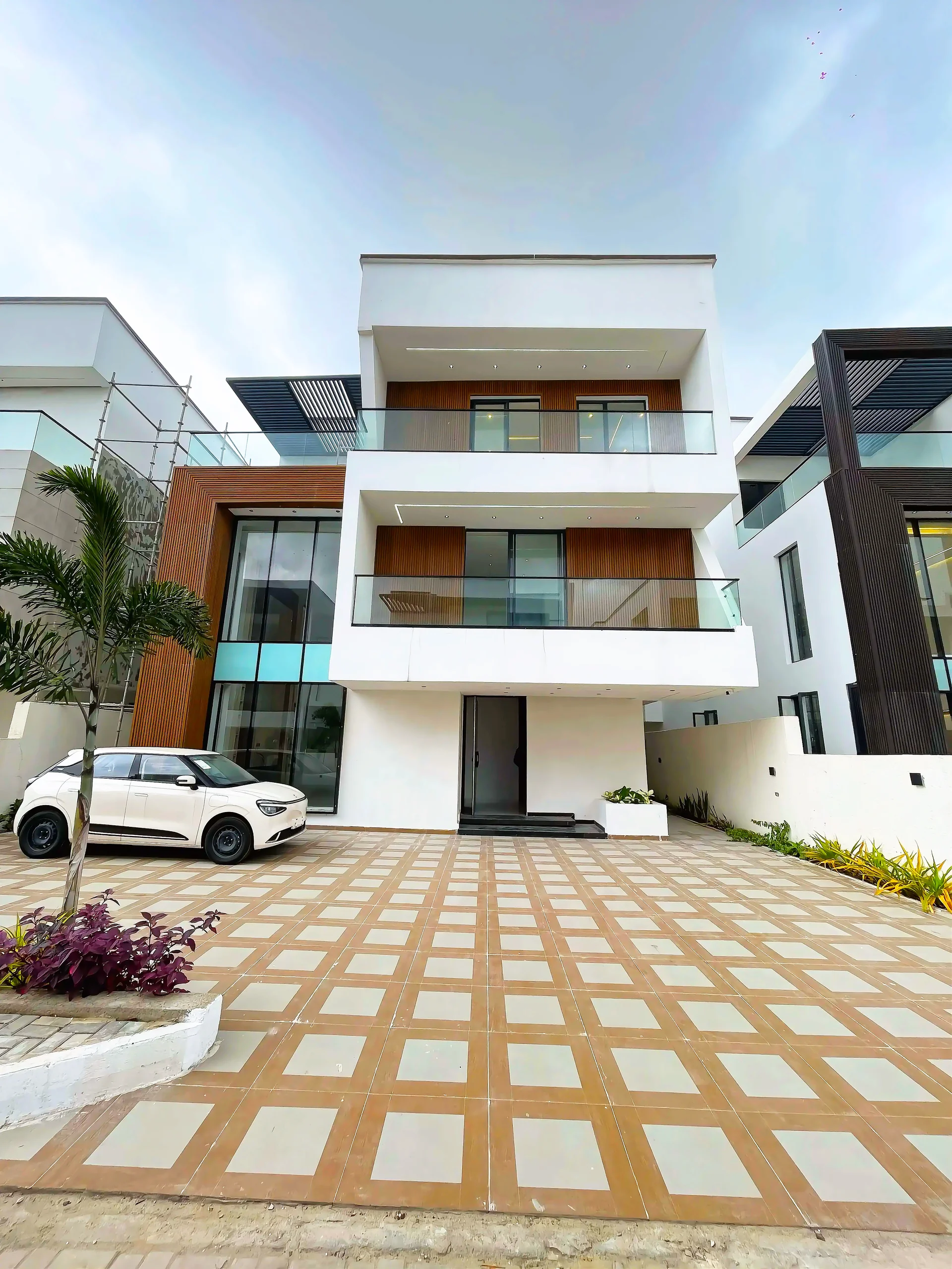 Modern luxury building exterior with glass facade reflecting city skyline